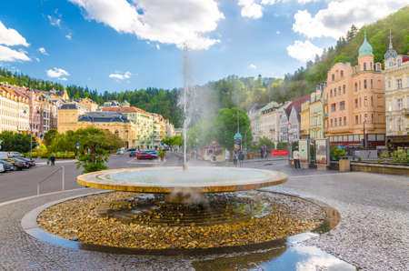 Karlovy Vary, Czech Republic, May 10, 2019: Hot spring geyser Vridlo at Carlsbad historical city centre, Tepla river embankment, colorful beautiful buildings, West Bohemiaのeditorial素材