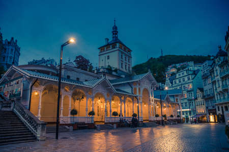 Karlovy Vary, Czech Republic, May 11, 2019: The Market Colonnade Trzni kolonada wooden colonnade with lights and hot springs in town Carlsbad historical city centre, night evening view, West Bohemiaのeditorial素材