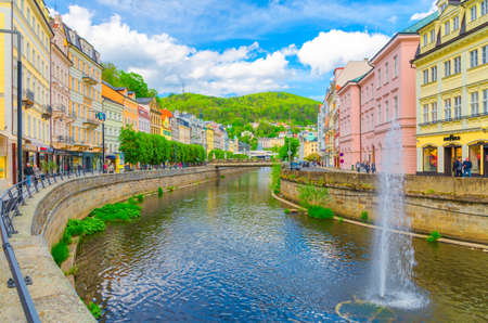 Karlovy Vary, Czech Republic, May 10, 2019: people are walking down street and Tepla river...