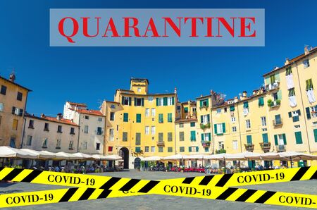 Quarantine in Italy. Anfiteatro square in circus yard of medieval town Lucca. No travel and lockdown concept. Coronavirus outbreak Covid-19 pandemic concept. Canceled tourist vacation. Barrier tape.の写真素材
