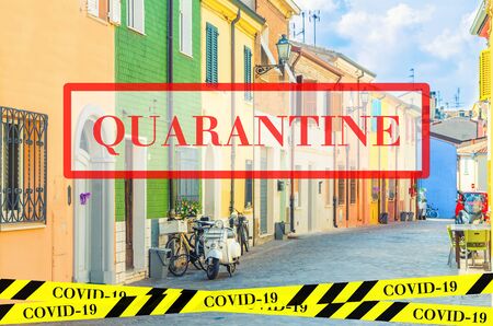 Quarantine in Italy. Typical italian buildings with colorful walls in Rimini. No travel and lockdown concept. Coronavirus outbreak Covid-19 pandemic concept. Canceled tourist vacation. Barrier tape.の写真素材