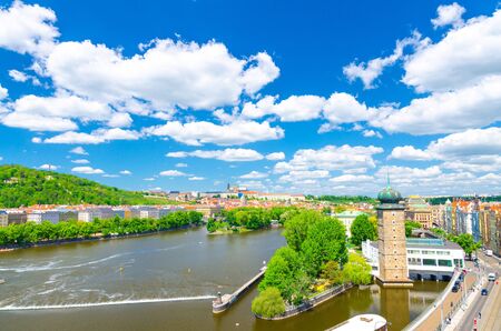 Aerial panoramic view of Prague city, historical center with Prague Castle, St. Vitus Cathedral, Hradcany district, Sitkovska Water-tower, Vltava river, blue sky white clouds, Bohemia, Czech Republicの写真素材