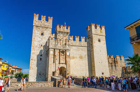 Sirmione, Italy, September 11, 2019: Scaligero Castle Castello fortress from Scaliger era, historical center of Sirmione town on Garda lake, medieval castle with stone towers brick walls, Lombardyのeditorial素材