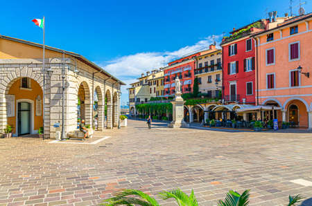 Desenzano del Garda, Italy, September 11, 2019: Vintage Antique market place and Angela Merici monument on Piazza Giuseppe Malvezzi square in historical town centre, blue sky background, Lombardyのeditorial素材