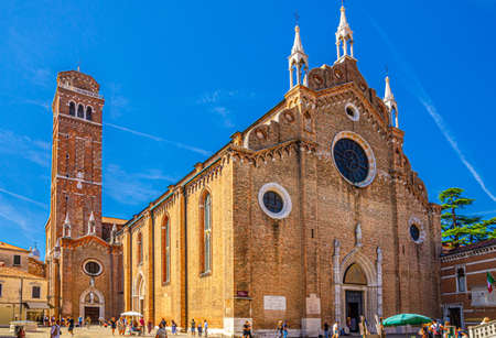 Venice, Italy, September 13, 2019: Basilica di Santa Maria Gloriosa dei Frari catholic church building with bell tower in historical city centre sestiere of San Polo, blue sky, Veneto Regionのeditorial素材