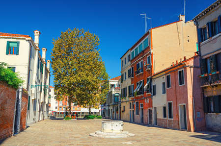 Venice, Italy, September 13, 2019: Campo San Simeone Grande square with colorful buildings, Grand Canal view, stone well in sestiere Santa Croce in historical city centre, Veneto Region, blue skyのeditorial素材