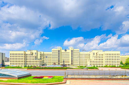 The Government House constructivism style building and Vladimir Lenin statue on Independence Square in Minsk city historical centre, blue sky white clouds in sunny summer day, Republic of Belarusの写真素材