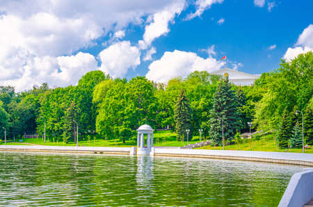 Minsk cityscape with Svislach or Svislac river embankment with gazebo and General Headquarters building in historical city centre, blue sky white clouds in sunny summer day, Republic of Belarusの写真素材