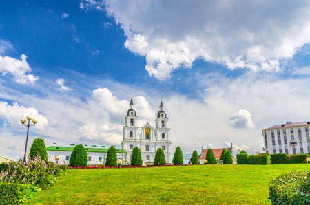 Holy Spirit Cathedral Orthodox Church Baroque style building and green grass lawn in Upper Town Minsk historical city centre, blue sky white clouds in sunny summer day, Republic of Belarusの写真素材