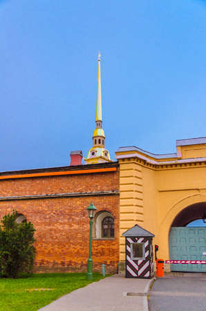 Watercolor drawing of Golden spire of Saints Peter and Paul Cathedral church over brick wall of Peter and Paul Fortress and guardhouse Sentry box on Zayachy Hare Island, Saint Petersburg city, Russiaの写真素材
