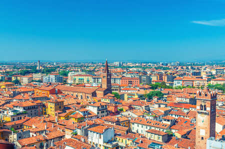 Aerial view of Verona city historical centre Citta Antica with red tiled roof buildings. Panoramic view of cityscape of Verona town. Blue sky background copy space. Veneto Region, Northern Italyの写真素材