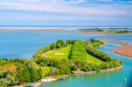Aerial view of Torcello islands swamp, water canal and green trees alley and bushes. Panoramic view...