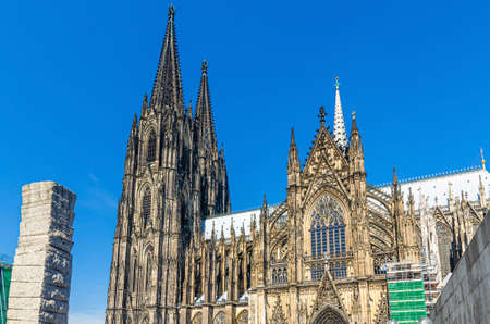 Cologne Cathedral Roman Catholic Church of Saint Peter gothic architectural style building with two huge spires in historical city center, blue sky in sunny day, North Rhine-Westphalia, Germanyの写真素材
