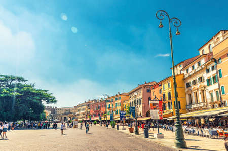 Verona, Italy, September 12, 2019: Piazza Bra square in historical city center with row of old colorful multicolored buildings cafes and restaurants and walking tourists people, Veneto Regionのeditorial素材