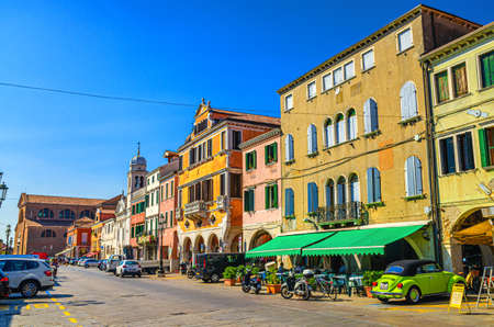 Chioggia, Italy, September 16, 2019: row of colorful multicolored buildings on main street Corso del Popolo in Chioggia town historical center, blue sky background in summer day, Veneto Regionのeditorial素材