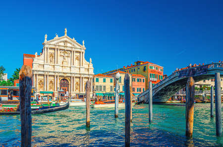 Venice, Italy, September 13, 2019: cityscape with yachts and gondolas sailing Grand Canal waterway, Ponte degli Scalzi bridge and Chiesa di Santa Maria di Nazareth church, blue sky in summer dayのeditorial素材