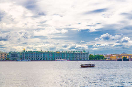 The State Hermitage Museum building, The Winter Palace official residence of the Russian Emperors on embankment, and boat ship on water of Neva river, Saint Petersburg Leningrad city, Russiaのeditorial素材