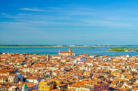 Aerial panoramic view of Venice city old historical center, buildings with red tiled roofs, Marco Polo airport background, Veneto Region, Northern Italy. Amazing Venice cityscape.の写真素材