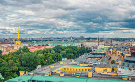 Top aerial panoramic view of Saint Petersburg Leningrad city with Alexander Garden, State Hermitage Museum, Winter Palace, Neva river, golden spire of Admiralty building, dramatic sky, Russiaの写真素材