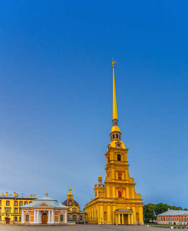 Saints Peter and Paul Cathedral Orthodox church with golden spire in Peter and Paul Fortress citadel on Zayachy Hare Island, evening dusk twilight view, Saint Petersburg Leningrad city, Russiaの写真素材