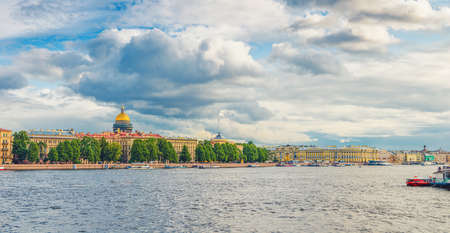 Panorama of Saint Petersburg city with row of old buildings on embankment of Neva river in historical center and golden dome of Saint Isaac's Cathedral background, Russia. Panoramic view of Leningradの写真素材