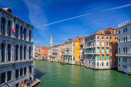 Grand Canal waterway in Venice historical city center with Palazzo Civran palace, Venetian colorful buildings and Church of the Holy Apostles of Christ bell tower. Veneto Region, Northern Italy.の写真素材