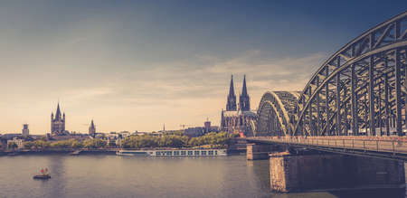 Panorama of Cologne city historical center with Cologne Cathedral of Saint Peter, Great Saint Martin Roman Catholic Church buildings and Hohenzollern Bridge across Rhine river. Cologne panoramic viewのeditorial素材