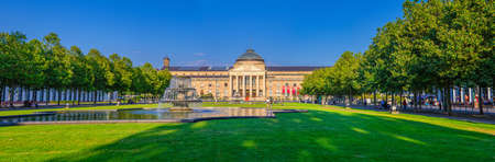 Wiesbaden, Germany, August 24, 2019: panorama of Kurhaus or cure house spa and casino building and Bowling Green park with grass lawn, trees alley and pond with fountain in historical city centerのeditorial素材