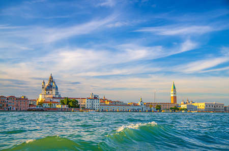 Venice cityscape with San Marco basin of Venetian lagoon water, Santa Maria della Salute church, Campanile bell tower and Doge's Palace Palazzo Ducale building, Veneto Region, Italyの写真素材