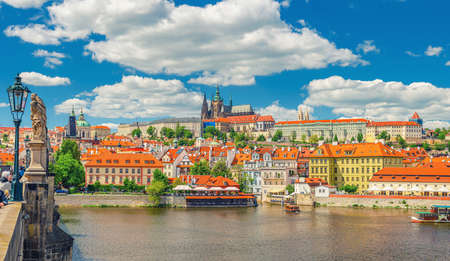Panorama of Prague city historical center with Prague Castle, St. Vitus Cathedral in Hradcany district, view from Charles Bridge Karluv Most across Vltava river. Blue sky white clouds, Czech Republicの写真素材