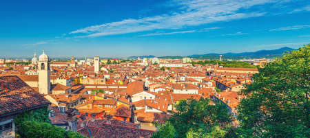 Aerial panoramic view of old historical city center of Brescia city with churches, towers and medieval buildings with red tiled roofs, Lombardy, Northern Italy. Cityscape of Brescia town.の写真素材