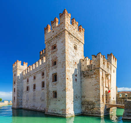 Scaligero Castle Castello di Sirmione fortress from Scaliger era in historical center of Sirmione town on Garda lake, medieval castle with stone towers, brick walls and water moat, Lombardy, Italyのeditorial素材