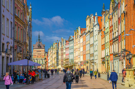 Gdansk, Poland, April 17, 2018: Golden gate Zlota Brama, Prison Tower, typical colorful houses buildings and people tourists walking down Dluga Street in old historical town centerのeditorial素材