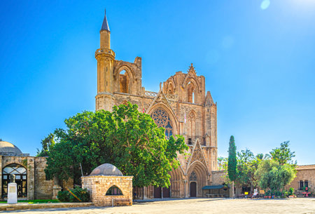 Lala Mustafa Pasha Camii Mosque or Old Cathedral of Saint Nicholas medieval building with minaret in Famagusta historical city center, clear blue sky in sunny day, Cyprusの写真素材