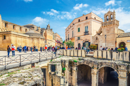 Matera, Italy - May 6, 2018: people tourists walking down Piazza Vittorio Veneto square with Church of Saint Dominic and Church of the Holy Spirit in Matera old town historical center, Basilicataのeditorial素材