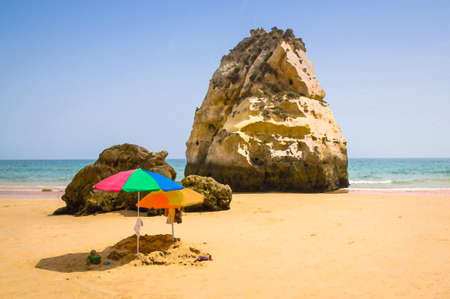 Watercolor drawing of two colored sun umbrellas on the beach, Portugal, Algarve, children's sandbox...