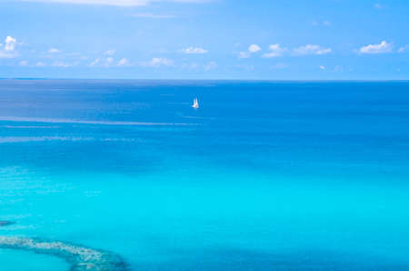 Watercolor drawing of Aerial view of beautiful amazing Tyrrhenian sea with turquoise water, tropical seascape with blue sky white clouds, small yacht background, Tropea, Calabria, Southern Italyの写真素材