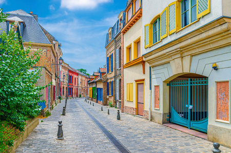 Narrow cobblestone street with colorful houses in Amiens historical city centre. Multicolored buildings of old town in France, Picardy, Somme department, Hauts-de-France Region, Northern Franceの写真素材