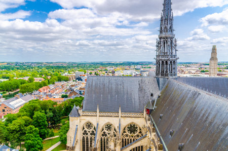 Aerial view from top of Amiens Cathedral with roof, fleche spire and panorama of Amiens old historical city center and outskirts districts, Somme department, Hauts-de-France Region, Northern Franceの写真素材