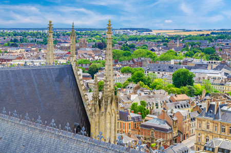 Aerial view from top of Amiens Cathedral with roof, fleche spire and panorama of Amiens old historical city center and outskirts districts, Somme department, Hauts-de-France Region, Northern Franceの写真素材