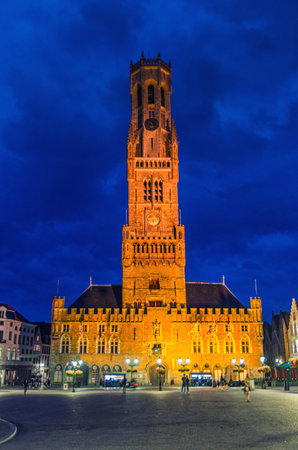 Belfry of Bruges Belfort van Brugge bell tower on Markt square in Brugge old town, Scheldt Gothic architecture style building in Bruges city historical centre, evening view, Flemish Region, Belgiumの写真素材