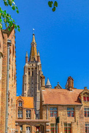 Roman Catholic Parish Church of Our Lady Gothic architecture style building with brickwork tower and Eleonora Verbeke Verbekehof museum, Brugge old town, Bruges city historical centre, Belgiumの写真素材