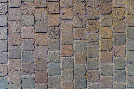 Cobblestone road texture, abstract background of cobblestone pavement close-up, old street stone paved textureの写真素材