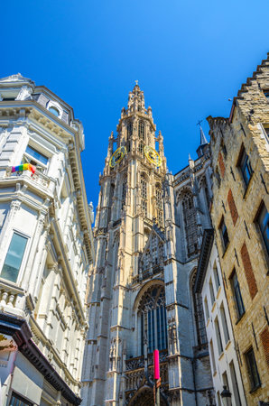 Cathedral of Our Lady Onze-Lieve-Vrouwekathedraal Roman Catholic Gothic style with belfry bell tower, vertical view between buildings, Antwerp city historical centre, Antwerpen old town, Belgiumの写真素材