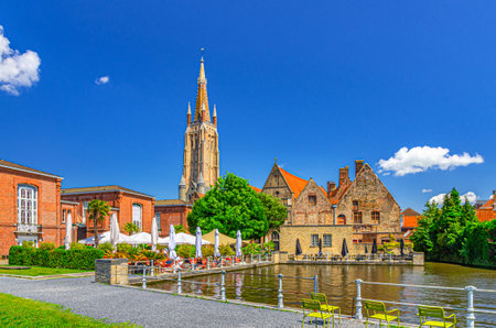 Bakkersrei water canal of Reie river with Church of Our Lady and Sint-Janshospitaal building in Brugge old town, Saint John embankment in Bruges city historical centre, Flemish Region, Belgiumの写真素材