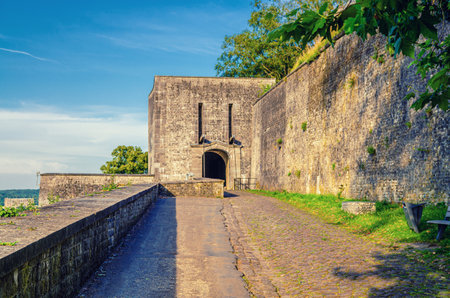 Stone paved road to Citadel of Namur Citadelle de Namur with stone wall and arch entrance, fortress...