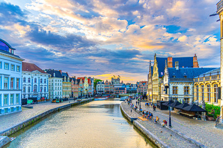 Graslei Grass Quay and Korenlei Corn Wheat Quay on bank of Leie river embankment in historic city center of Ghent town with row of historical buildings guild houses, Flemish Region, Belgiumの写真素材