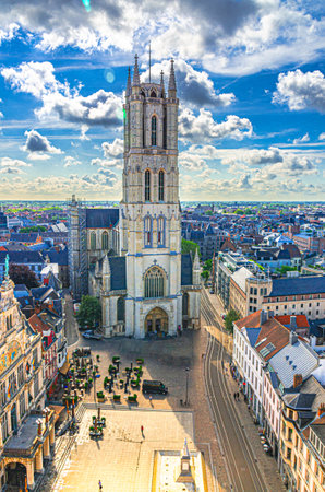 Sint-Baafs Cathedral of Saint Bavo Roman Catholic Church on Sint-Baafsplein square, aerial vertical view of Ghent city historical centre, skyline horizon with blue sky, Gent old town, Belgiumの写真素材