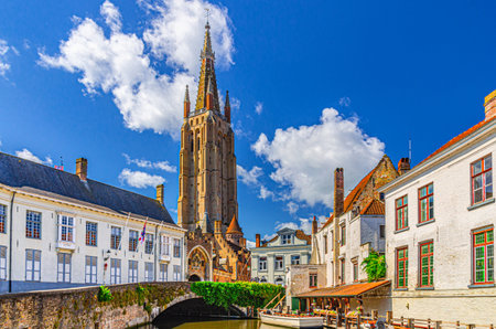 Roman Catholic Parish Church of Our Lady Gothic architecture style with brickwork tower, Gruuthusebrug Gruuthuse bridge across Dijver water canal in Brugge old town, Flemish Region, Belgiumの写真素材