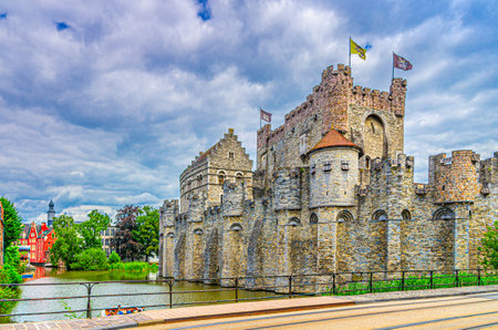 The Castle of the Counts Gravensteen medieval castle with stone walls on bank of Lieve water canal in Ghent historical city centre, Gent old town, East Flanders province, Flemish Region, Belgiumの写真素材
